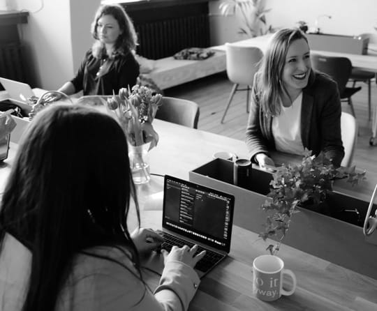 Photo of three women discussing